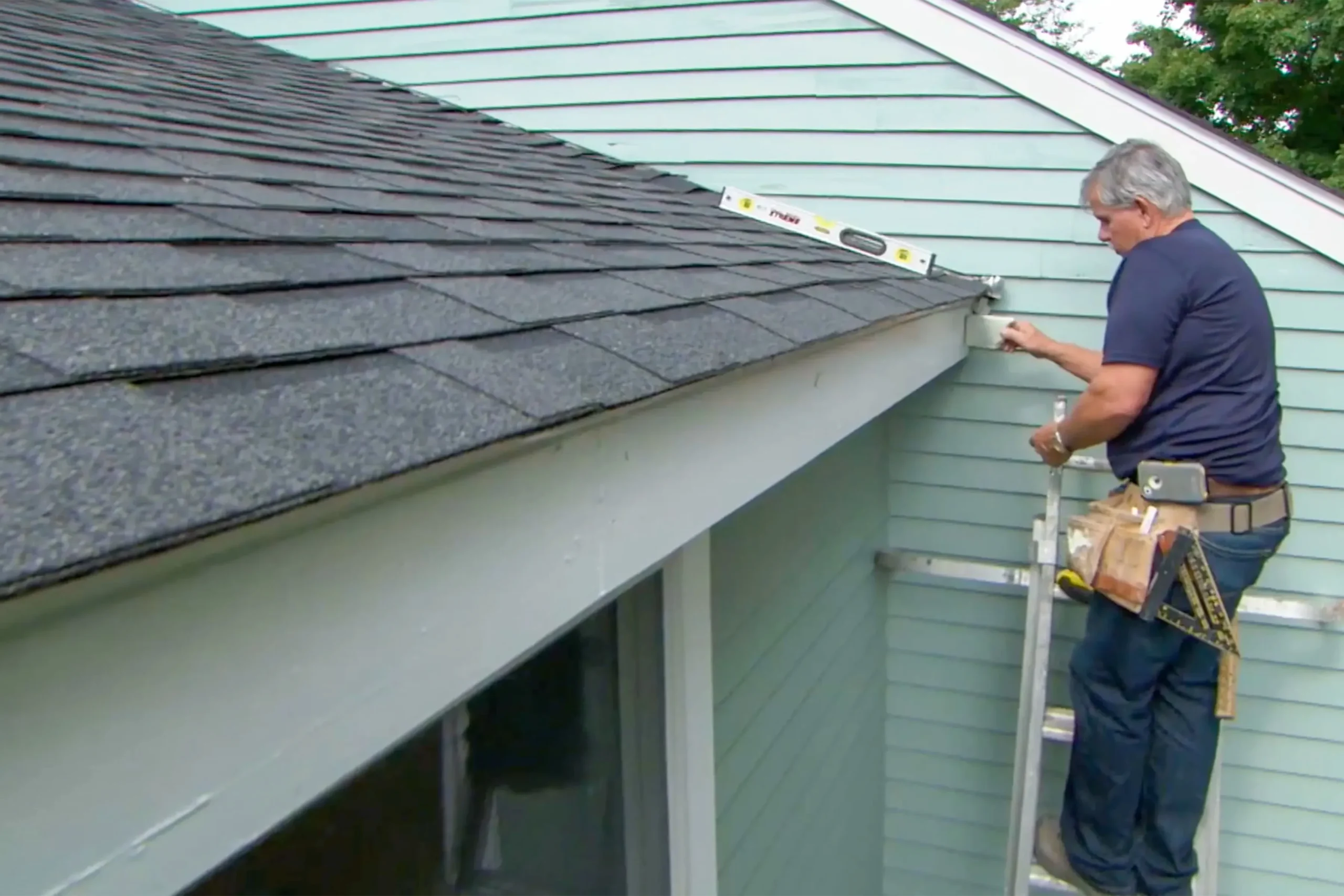 gutter installing services Expert providing gutter installing services on a residential home in Texas, ensuring proper drainage and protection.